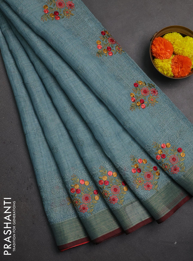 Linen saree pastel blue and maroon with allover embroidery weaves and embroidery pallu & border