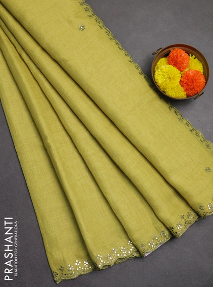 Art linen saree lime green with embroidery mirror work buttas and convent embroidery pallu