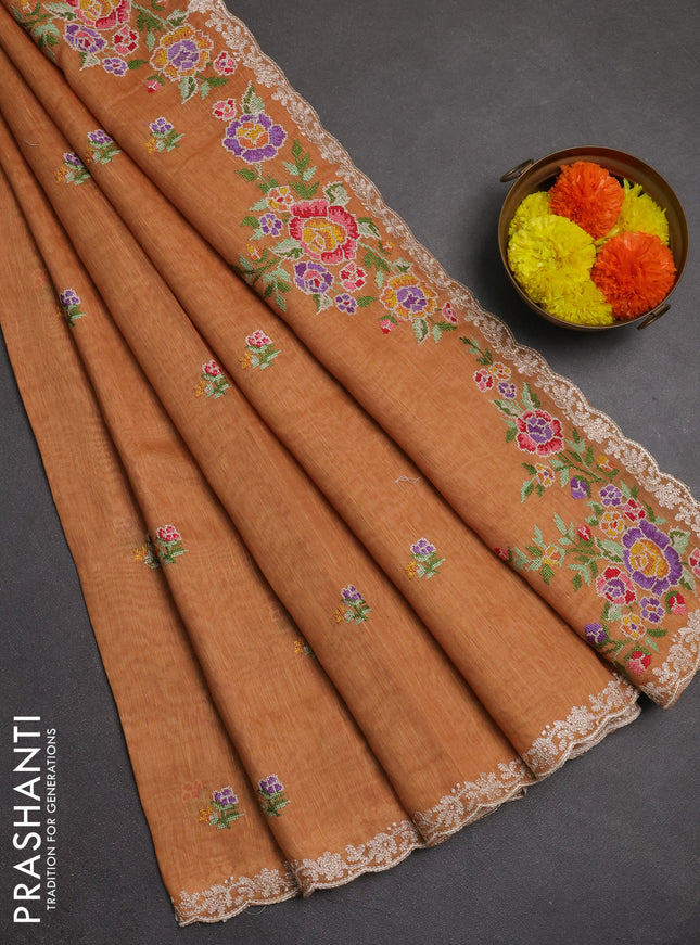 Art linen saree orange shade with allover convent embroidery buttas and embroidery border
