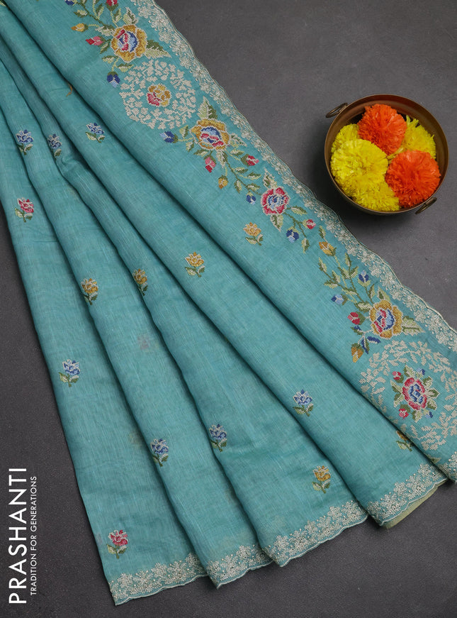 Art linen saree teal blue with allover convent embroidery buttas and embroidery border