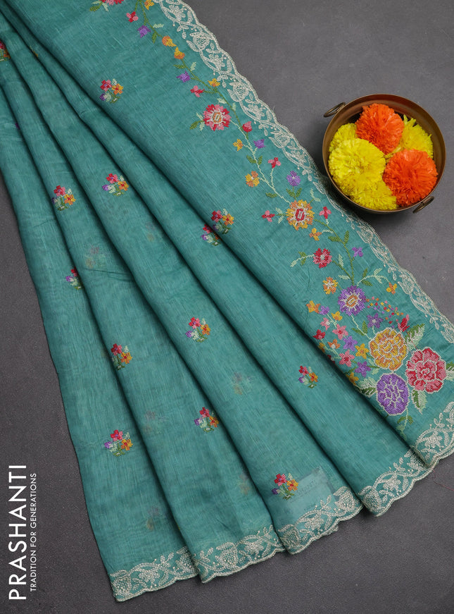 Art linen saree teal blue with allover convent embroidery buttas and embroidery border