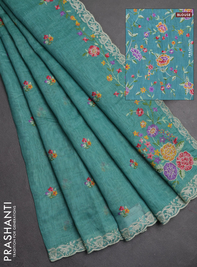 Art linen saree teal blue with allover convent embroidery buttas and embroidery border