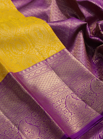 Pure kanchipuram silk saree yellow and purple with allover zari woven brocade weaves and long rich zari woven border