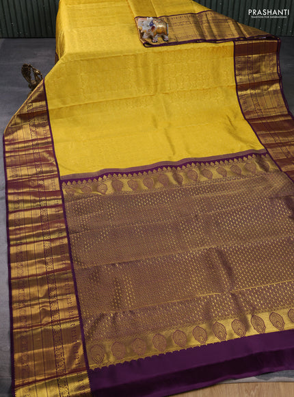 Pure kanchipuram silk saree yellow and deep purple with allover zari woven brocade weaves and long rich zari woven border