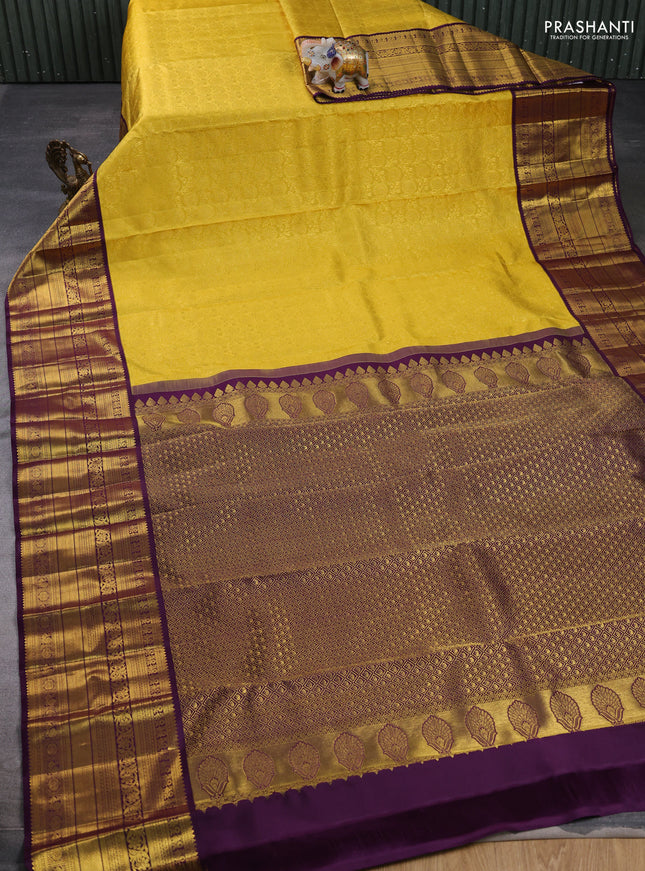Pure kanchipuram silk saree yellow and deep purple with allover zari woven brocade weaves and long rich zari woven border