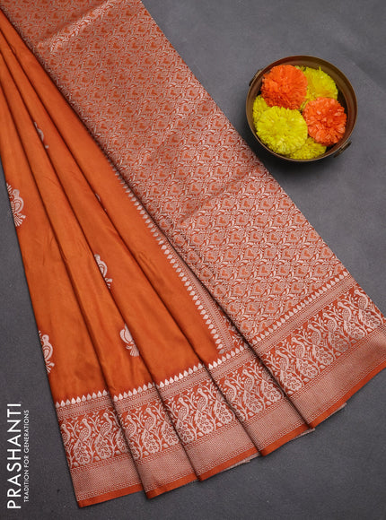 Semi soft silk saree rust shade with allover zari woven buttas and zari woven border