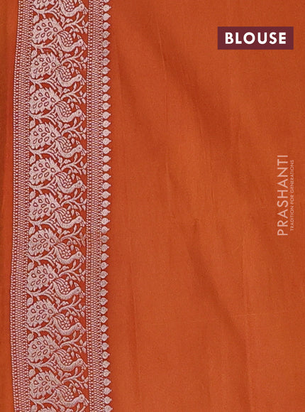 Semi soft silk saree rust shade with allover zari woven buttas and zari woven border