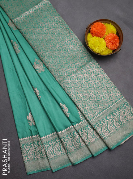 Semi soft silk saree pastel green with allover zari woven buttas and zari woven border