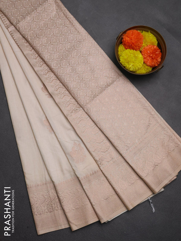 Semi soft silk saree cream with allover zari woven buttas and zari woven border
