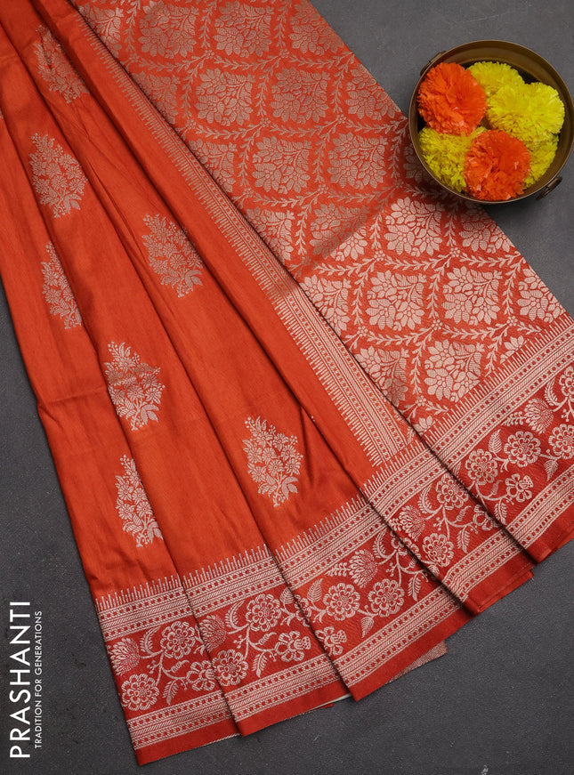 Semi soft silk saree rust shade with floral zari woven buttas and zari woven border
