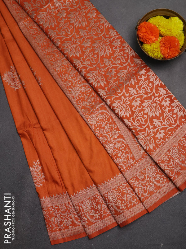 Semi soft silk saree rust shade with floral zari woven buttas and zari woven border