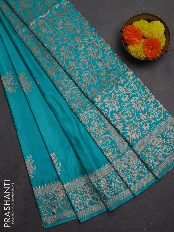 Semi soft silk saree teal green with floral zari woven buttas and zari woven border