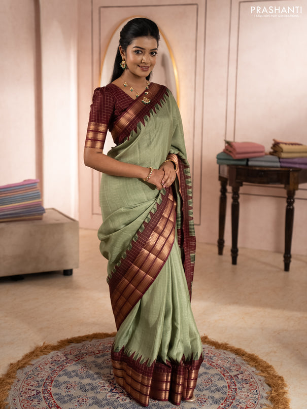 Semi raw silk saree pastel green and maroon with allover zari checked pattern and temple design zari woven border