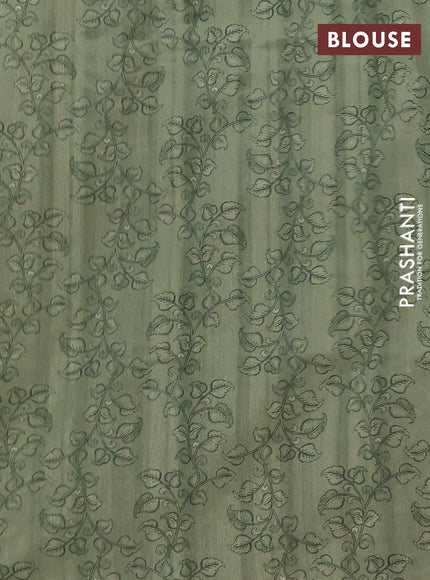 Semi raw silk saree pastel green and coffee brown with plain body and long kalamkari printed embroidery border
