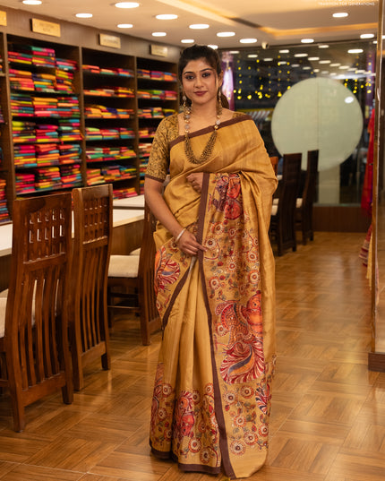 Semi raw silk saree mustard yellow and coffee brown with plain body and long kalamkari printed embroidery border