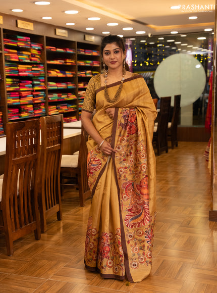 Semi raw silk saree mustard yellow and coffee brown with plain body and long kalamkari printed embroidery border