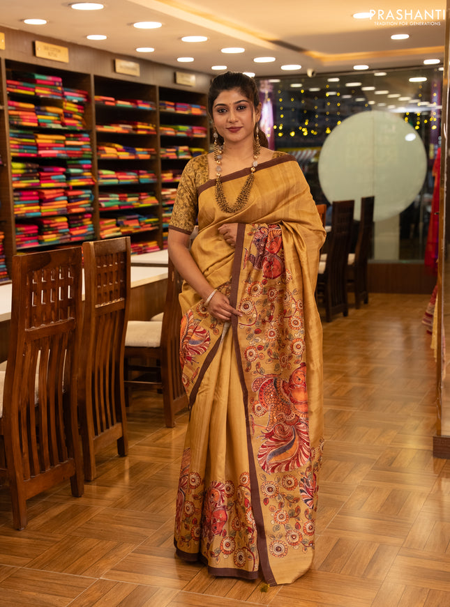 Semi raw silk saree mustard yellow and coffee brown with plain body and long kalamkari printed embroidery border