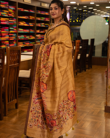 Semi raw silk saree mustard yellow and coffee brown with plain body and long kalamkari printed embroidery border