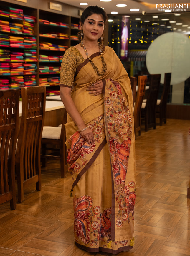 Semi raw silk saree mustard yellow and coffee brown with plain body and long kalamkari printed embroidery border