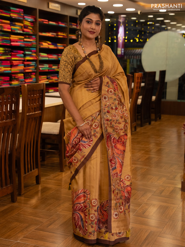Semi raw silk saree mustard yellow and coffee brown with plain body and long kalamkari printed embroidery border
