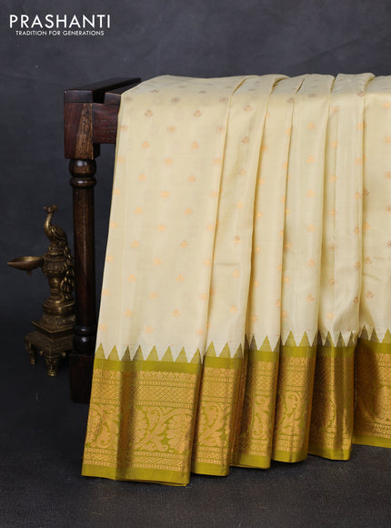 Pure gadwal silk saree cream and mehendi green with allover zari woven buttas and temple design zari woven border