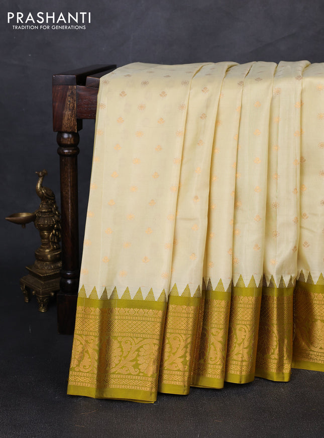Pure gadwal silk saree cream and mehendi green with allover zari woven buttas and temple design zari woven border