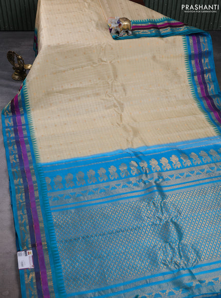 Pure gadwal silk saree cream and teal blue with allover zari checks & buttas and temple design zari woven border