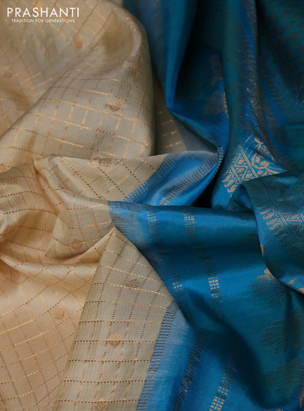 Pure gadwal silk saree cream and teal blue with allover zari checks & buttas and temple design zari woven border