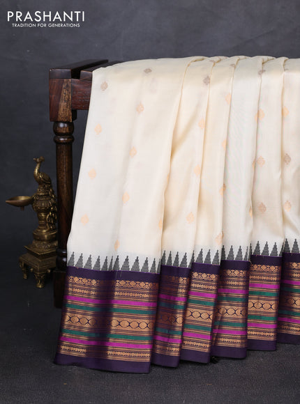 Pure gadwal silk saree cream and navy blue with allover zari woven buttas and temple design zari woven border