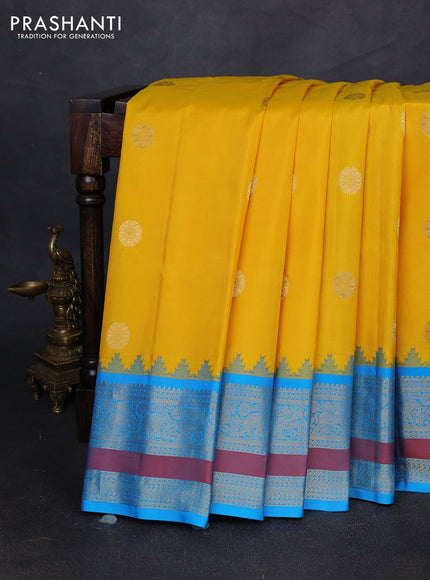 Pure gadwal silk saree yellow and cs blue with allover zari woven buttas and temple design zari woven border