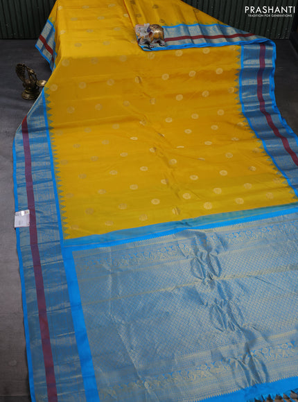 Pure gadwal silk saree yellow and cs blue with allover zari woven buttas and temple design zari woven border