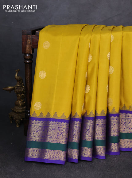 Pure gadwal silk saree mustard yellow and blue with allover zari woven buttas and temple design zari woven border