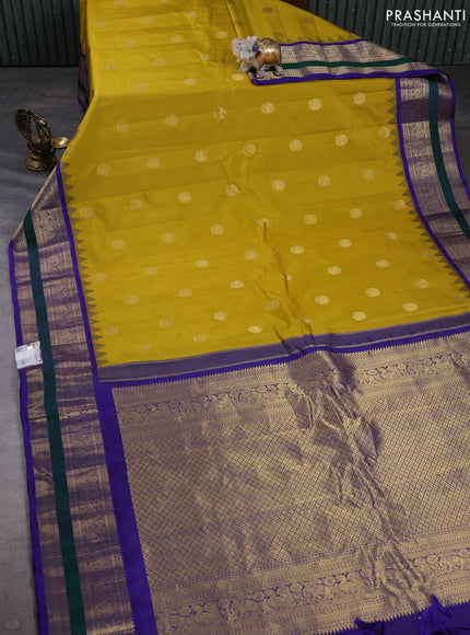 Pure gadwal silk saree mustard yellow and blue with allover zari woven buttas and temple design zari woven border