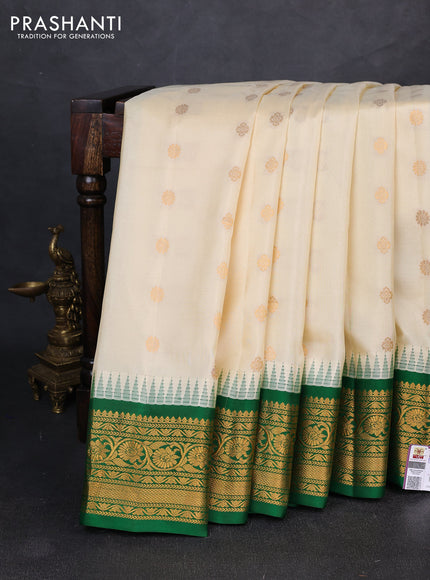 Pure gadwal silk saree off white and green with allover zari woven buttas and temple design zari woven border