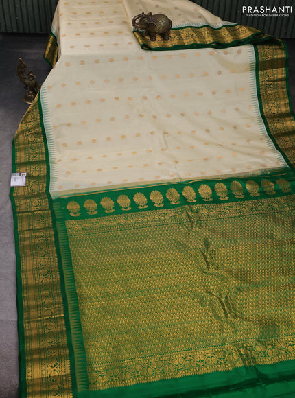 Pure gadwal silk saree off white and green with allover zari woven buttas and temple design zari woven border