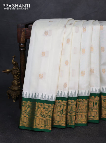 Pure gadwal silk saree off white and bottle green with allover zari woven buttas and temple design zari woven border