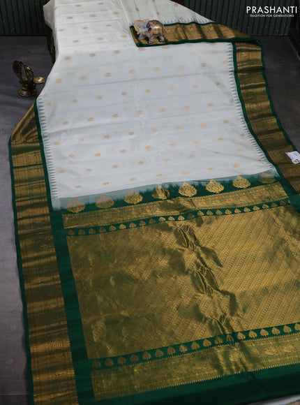 Pure gadwal silk saree off white and bottle green with allover zari woven buttas and temple design zari woven border