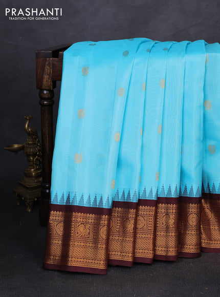 Pure gadwal silk saree teal blue and coffee brown with allover zari woven buttas and temple design zari woven border