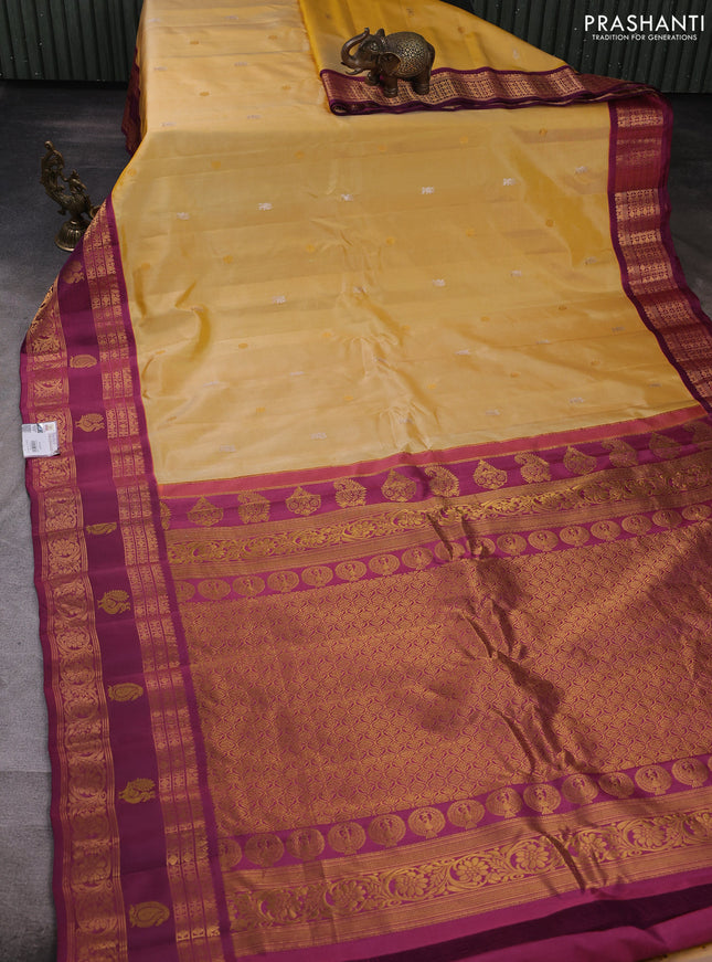 Pure gadwal silk saree pale yellow and magenta pink with allover zari woven buttas and rettapet zari woven korvai border