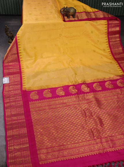 Pure gadwal silk saree yellow and pink with allover zari woven buttas and temple design zari woven border