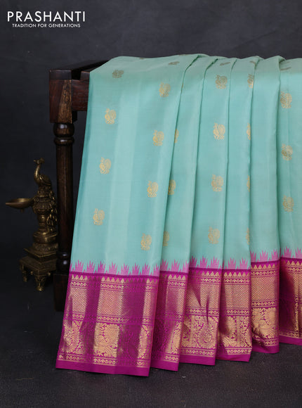 Pure gadwal silk saree mild teal and magenta pink with allover zari woven buttas and temple design zari woven border
