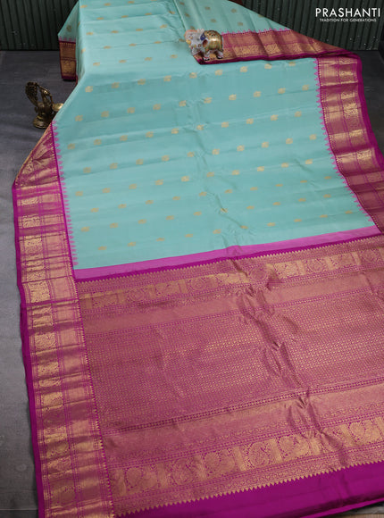 Pure gadwal silk saree mild teal and magenta pink with allover zari woven buttas and temple design zari woven border