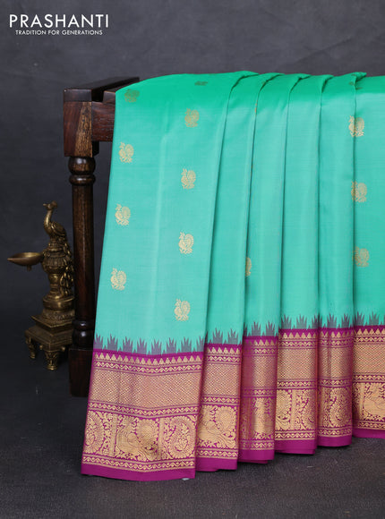 Pure gadwal silk saree teal green and purple with allover annam zari woven buttas and temple design zari woven border