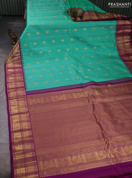 Pure gadwal silk saree teal green and purple with allover annam zari woven buttas and temple design zari woven border