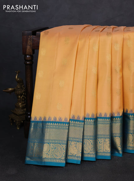 Pure gadwal silk saree sandal and peacock blue with allover zari woven buttas and temple design zari woven border