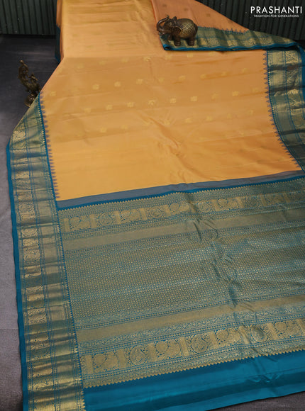 Pure gadwal silk saree sandal and peacock blue with allover zari woven buttas and temple design zari woven border