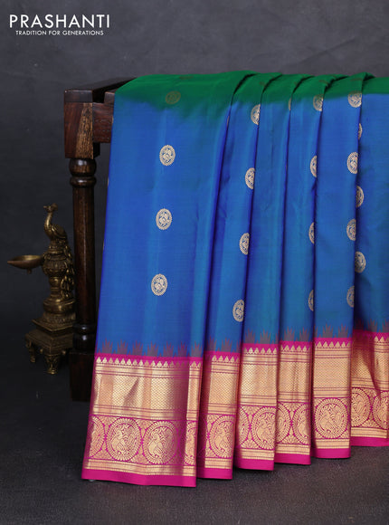 Pure gadwal silk saree dual shade of bluish green and pink with allover zarii woven buttas and temple design zari woven border