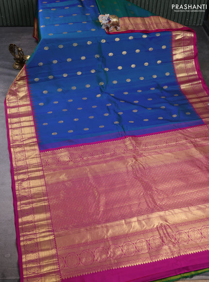 Pure gadwal silk saree dual shade of bluish green and pink with allover zarii woven buttas and temple design zari woven border