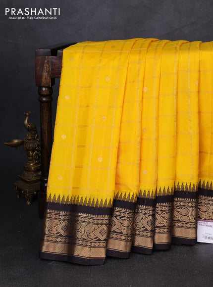 Pure gadwal silk saree yellow and coffee brown with allover zari checks & buttas and temple design zari woven border