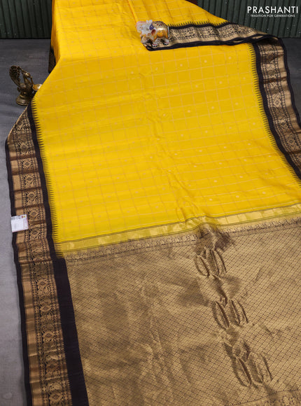 Pure gadwal silk saree yellow and coffee brown with allover zari checks & buttas and temple design zari woven border